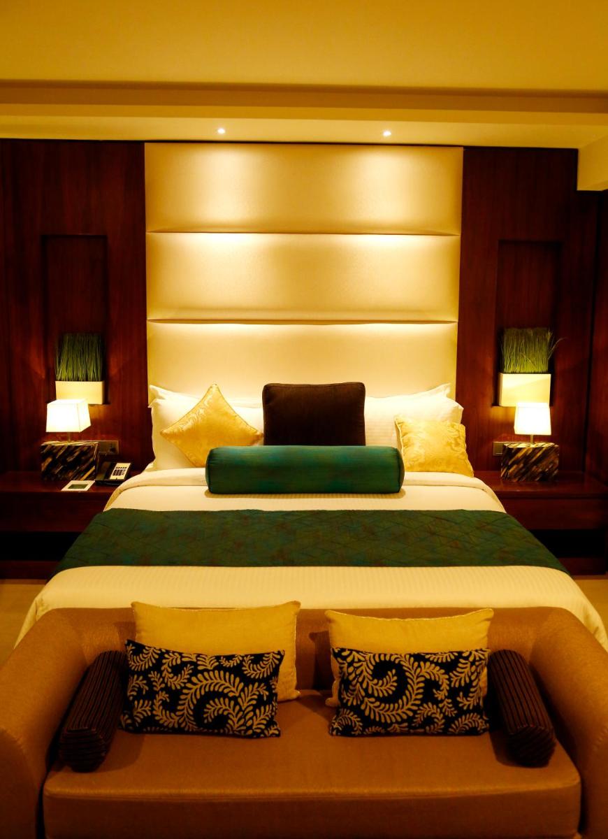 a large bed in a room with two pillows at The Raviz Calicut in Kozhikode