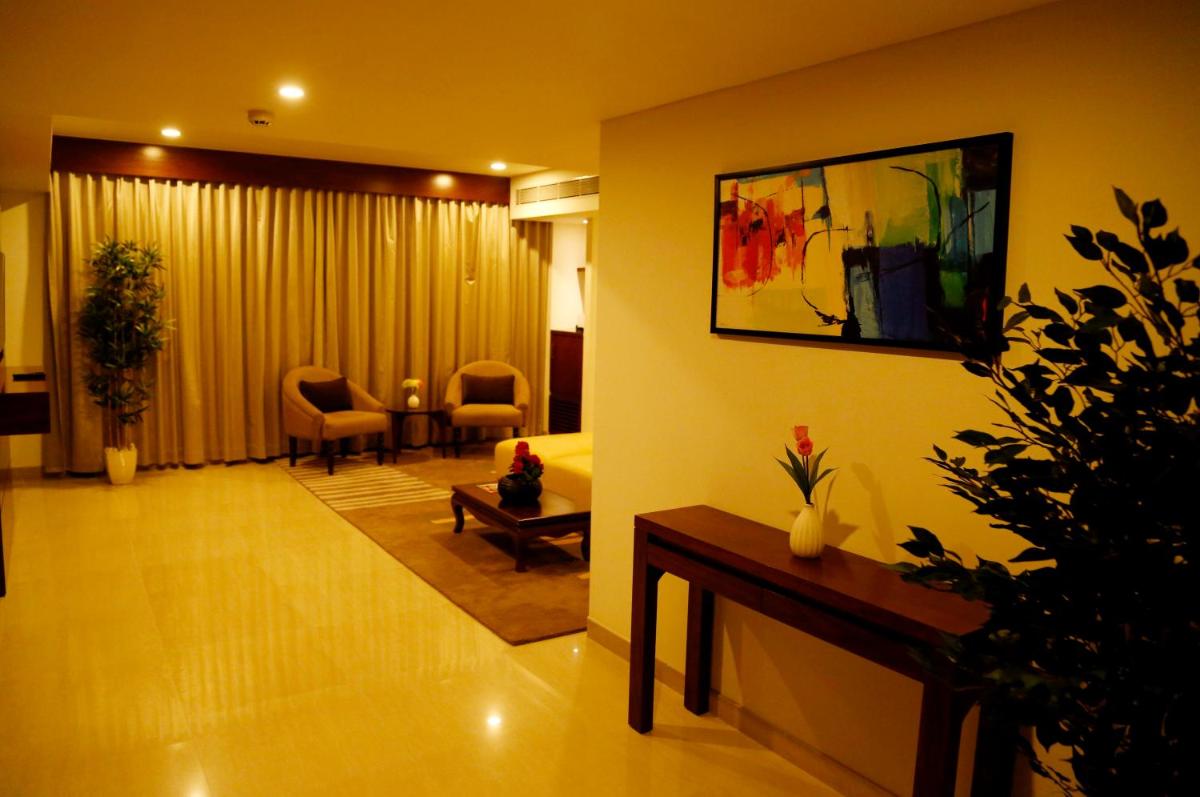 a living room with a couch and a table at The Raviz Calicut in Kozhikode