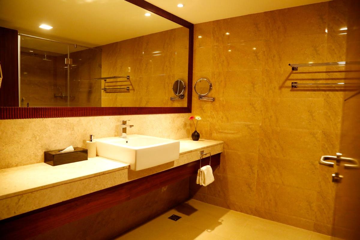 a bathroom with a sink and a mirror at The Raviz Calicut in Kozhikode