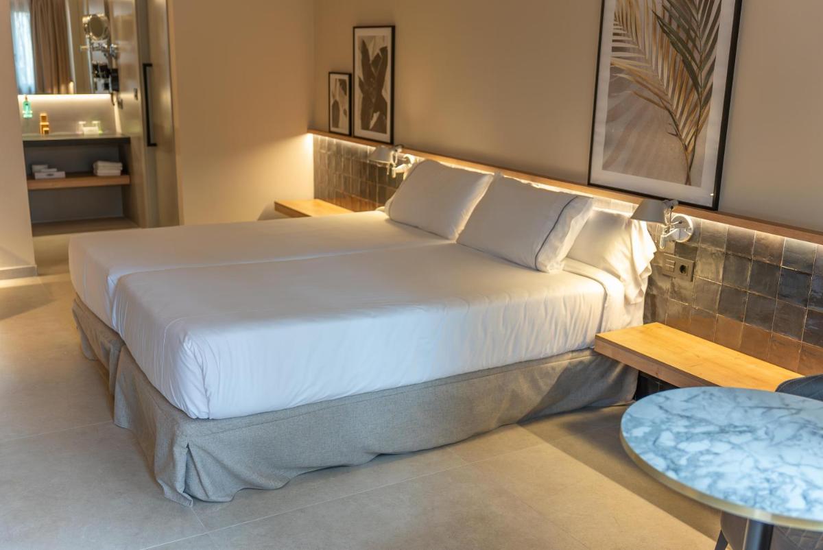 Cama o camas de una habitación en Hotel Huerto del Cura