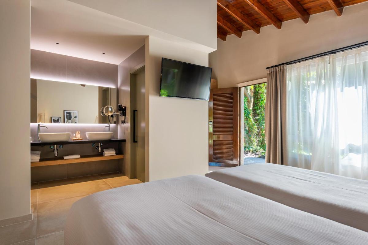Cama o camas de una habitación en Hotel Huerto del Cura