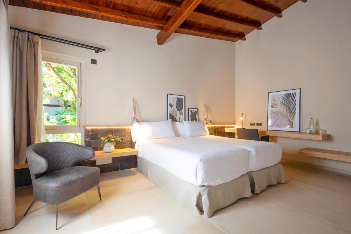 Cama o camas de una habitación en Hotel Huerto del Cura