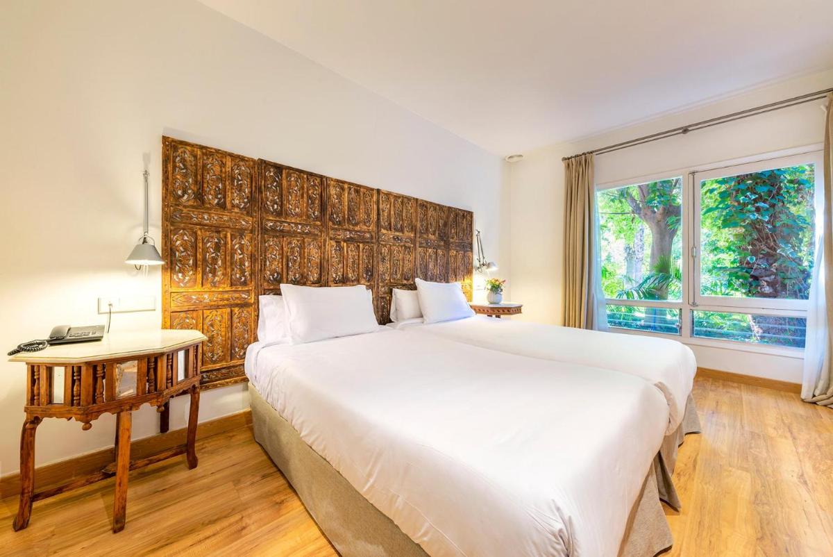 Cama o camas de una habitación en Hotel Huerto del Cura