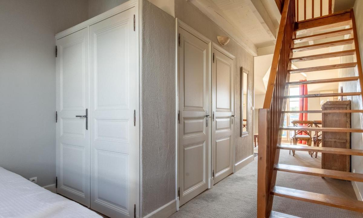 Un ou plusieurs lits dans un hébergement de l'établissement Eco-Domaine La Fontaine - RESIDENCE-SPA - Plage de la Fontaine aux Bretons