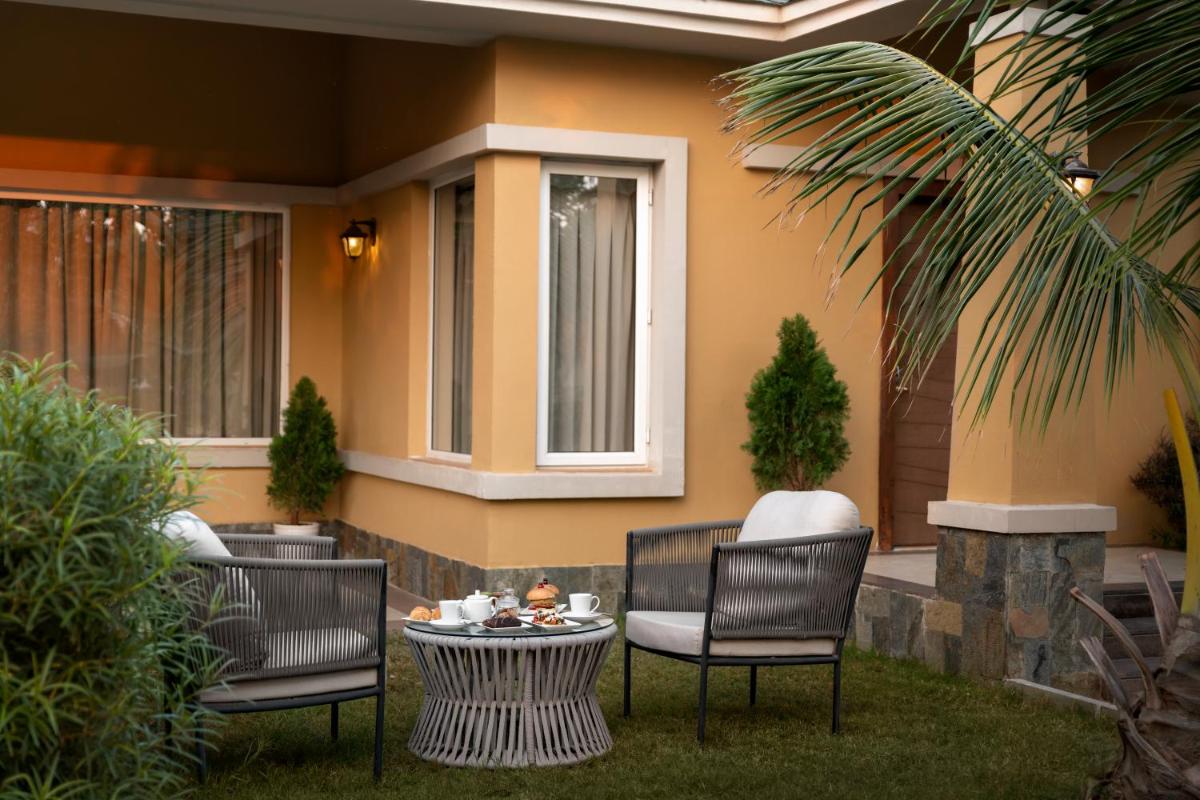 a group of chairs and a table on a patio at Hawthorn Suites by Wyndham Dwarka in Dwarka a group of chairs and a table on a patio at Hawthorn Suites by Wyndham Dwarka in Dwarka