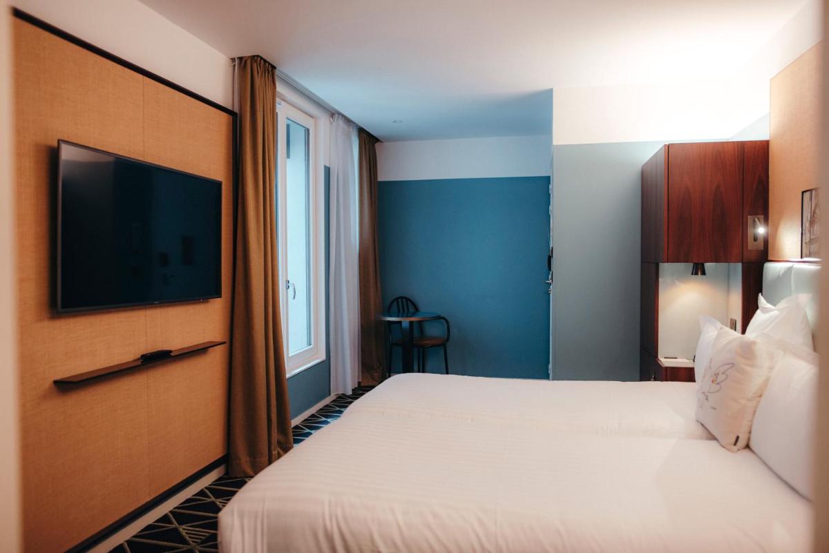 Un ou plusieurs lits dans un hébergement de l'établissement Hotel Eiffel Blomet
