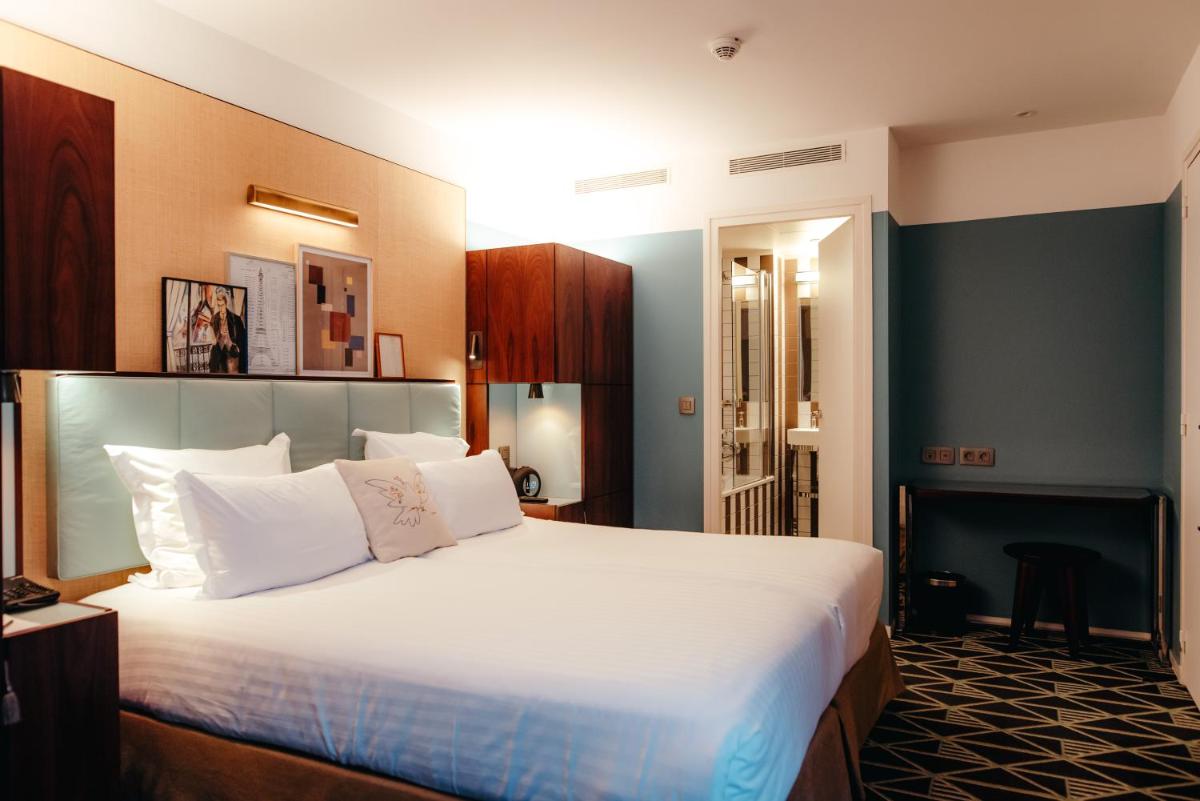 Un ou plusieurs lits dans un hébergement de l'établissement Hotel Eiffel Blomet