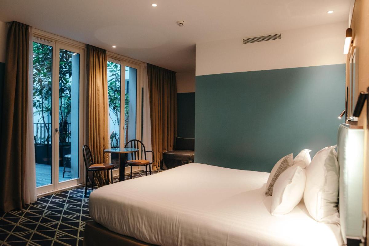 Un ou plusieurs lits dans un hébergement de l'établissement Hotel Eiffel Blomet