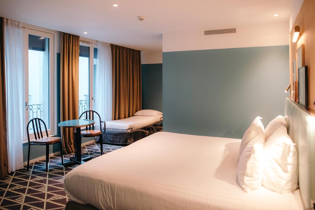 Un ou plusieurs lits dans un hébergement de l'établissement Hotel Eiffel Blomet