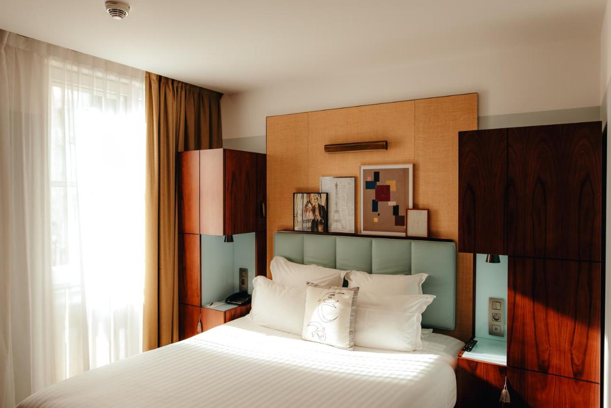 Un ou plusieurs lits dans un hébergement de l'établissement Hotel Eiffel Blomet