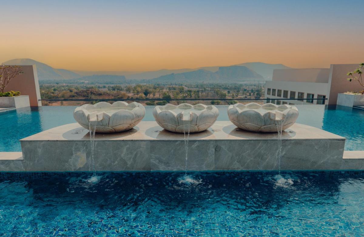 three bowls sitting on a table in a swimming pool at Taj Amer, Jaipur in Jaipur