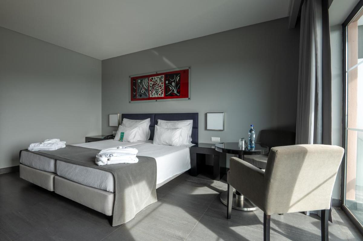 Uma cama ou camas num quarto em Vila Gale Lagos