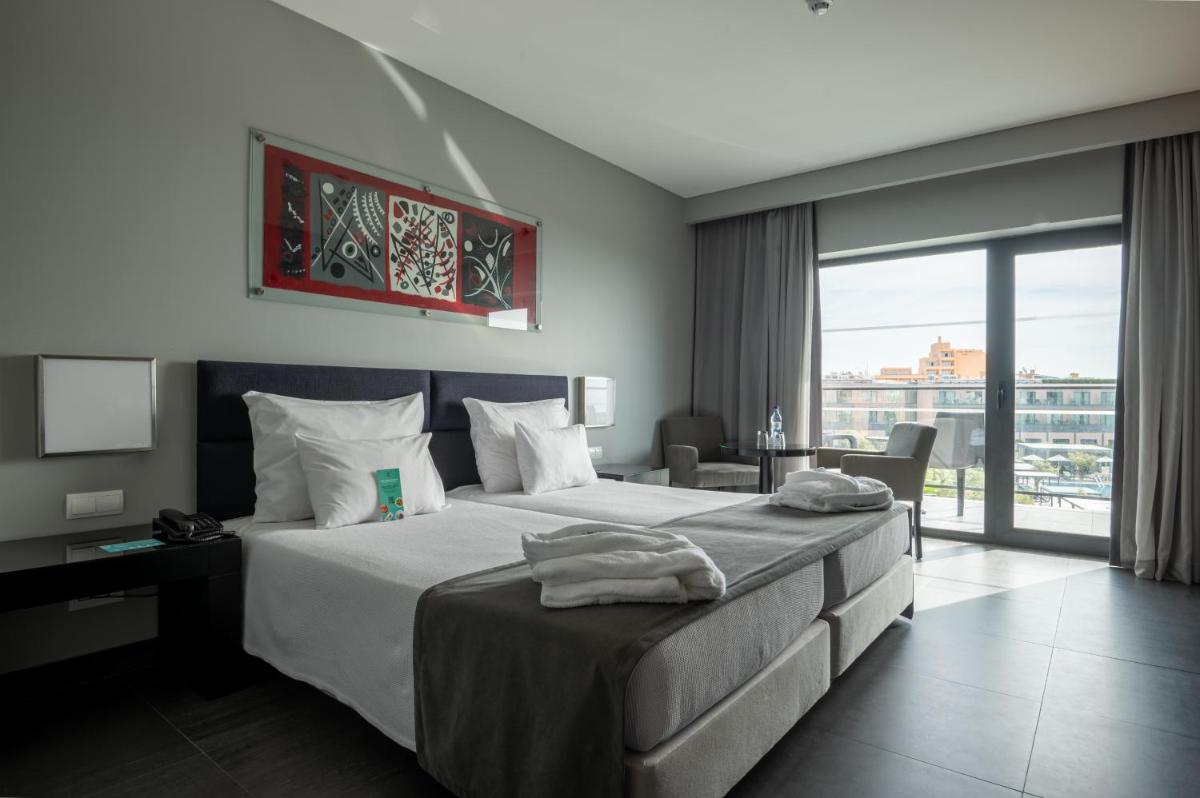 Uma cama ou camas num quarto em Vila Gale Lagos