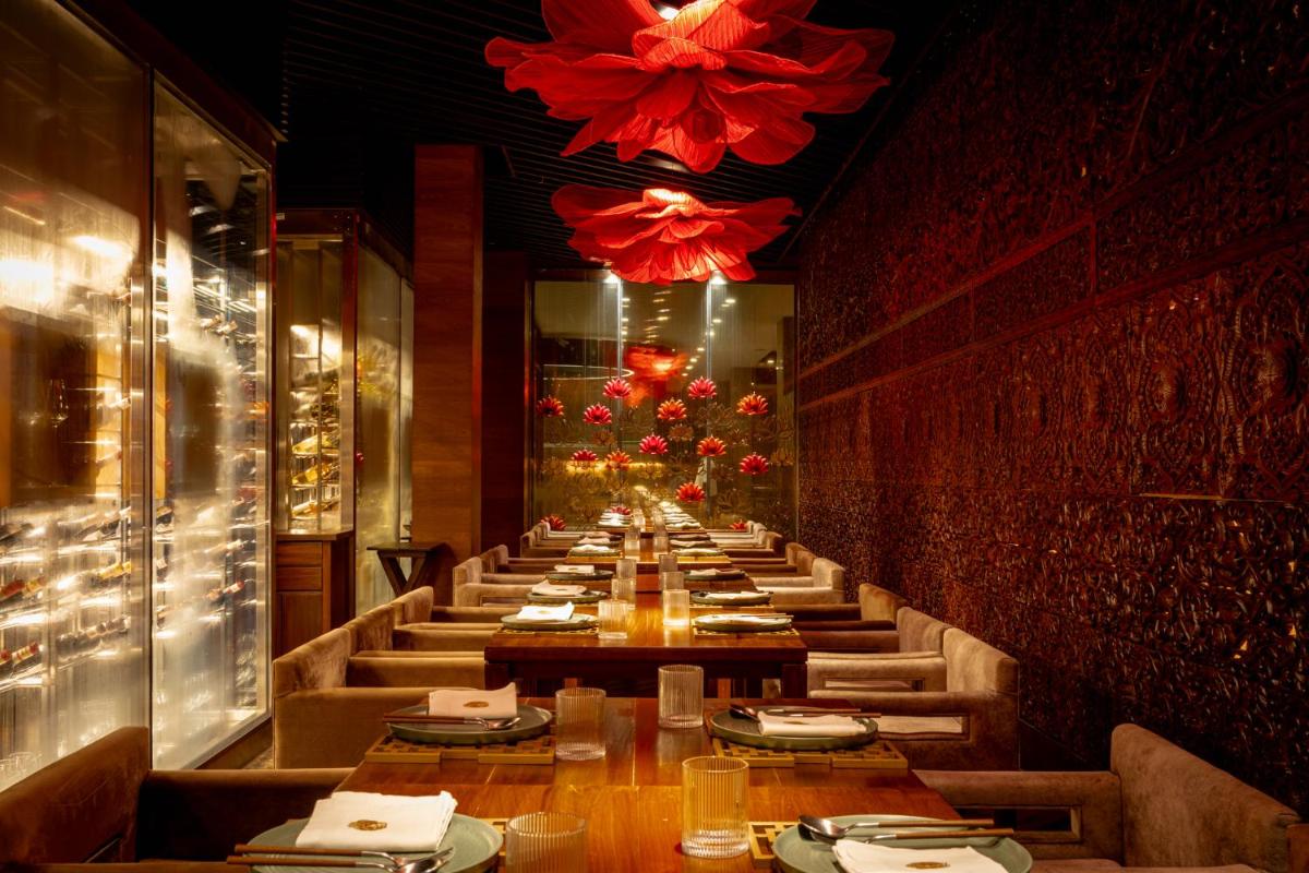 a long row of tables in a restaurant at President - IHCL SeleQtions in Mumbai