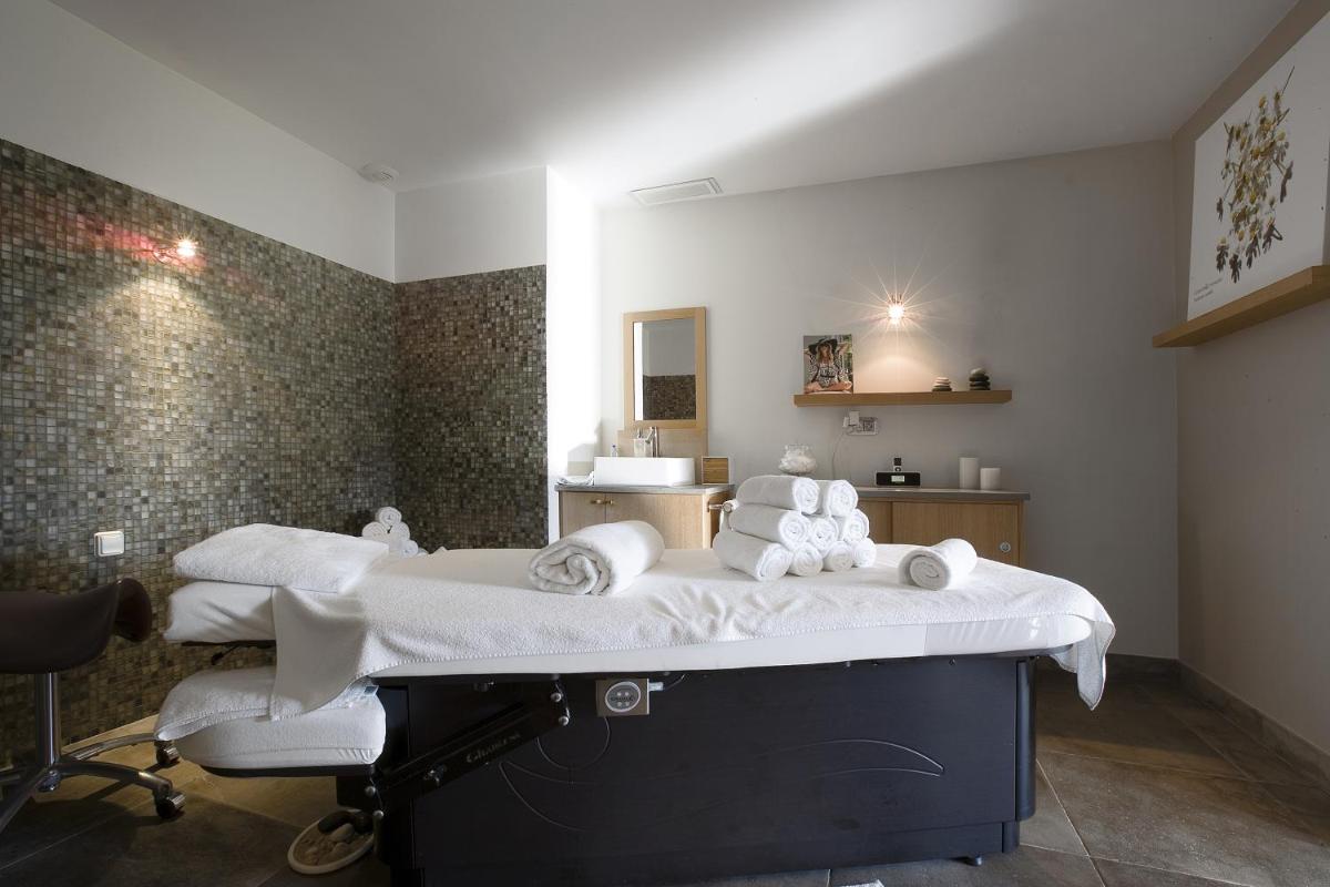 Un ou plusieurs lits dans un hébergement de l'établissement Le Clos Saint-Martin Hôtel & Spa