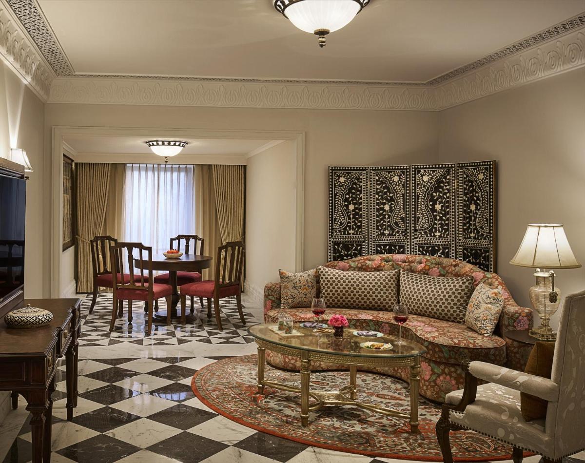 a living room with a couch and a table at Jai Mahal Palace in Jaipur