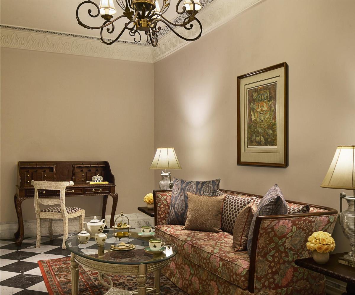 a living room with a couch and a table at Jai Mahal Palace in Jaipur
