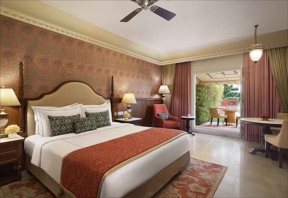 a hotel room with a bed and a patio at Jai Mahal Palace in Jaipur