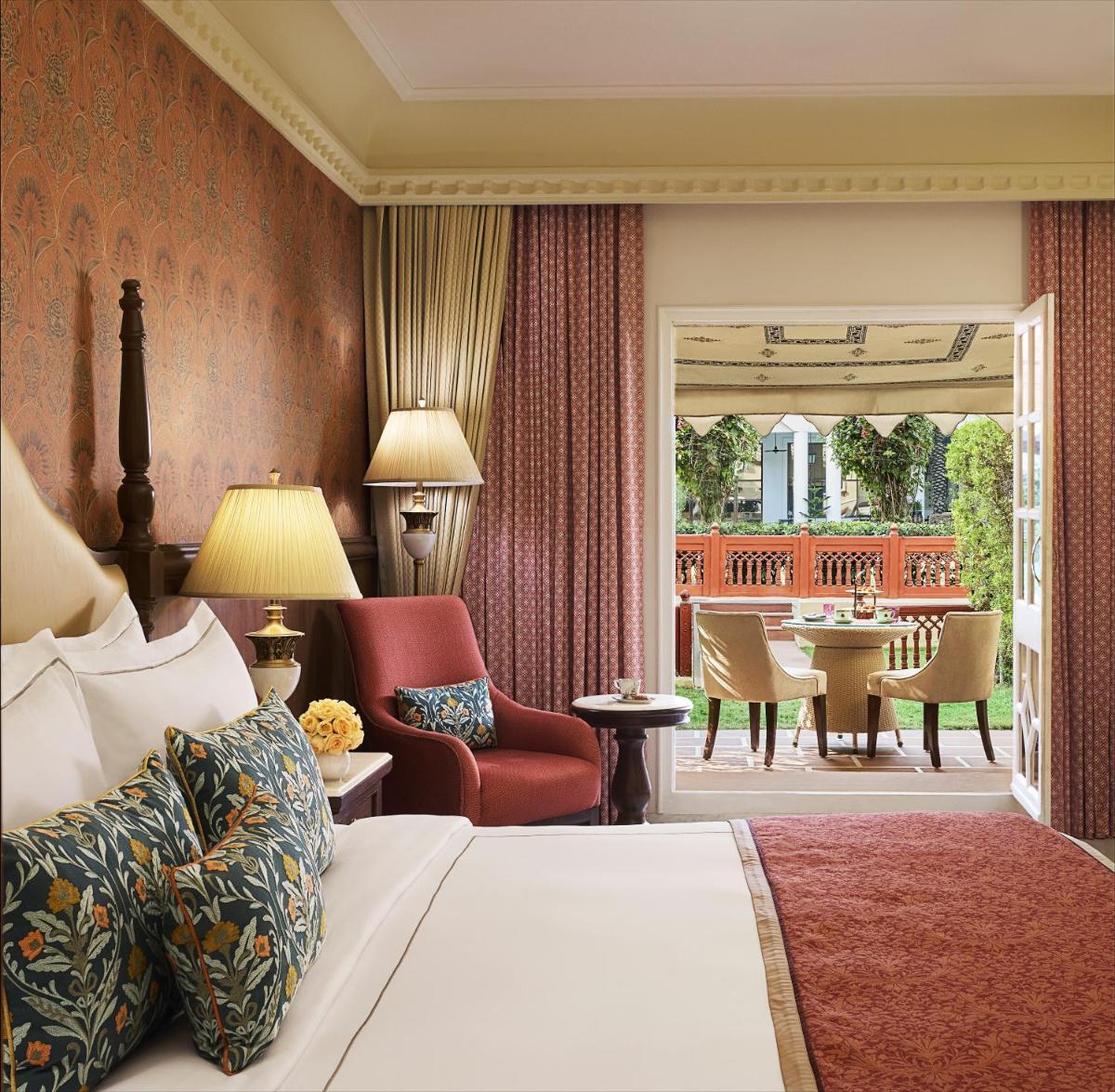 a hotel room with a bed and a patio at Jai Mahal Palace in Jaipur