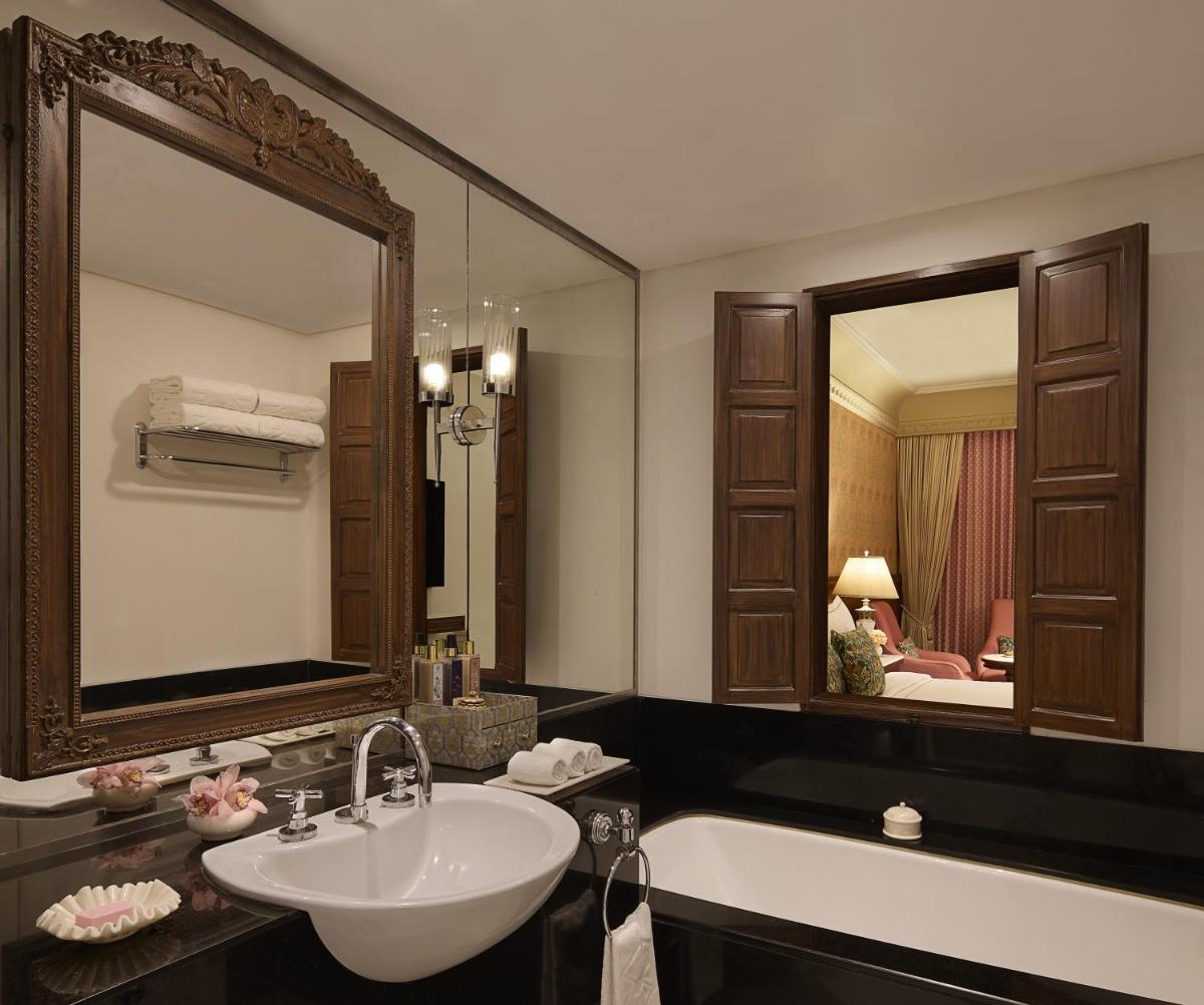 a bathroom with a sink and a large mirror at Jai Mahal Palace in Jaipur