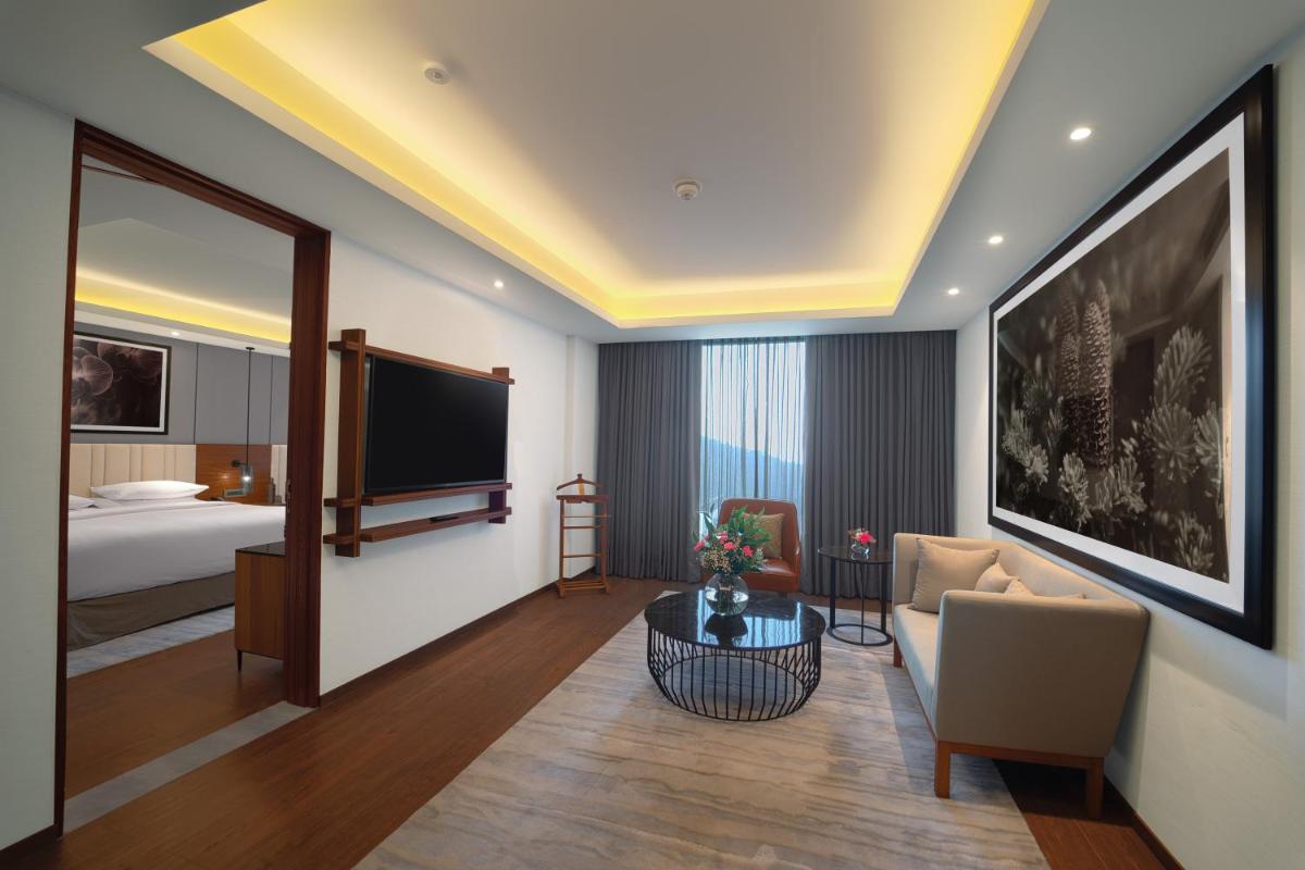 a hotel room with a bed and a television at Hyatt Regency Dehradun Resort and Spa in Dehradun