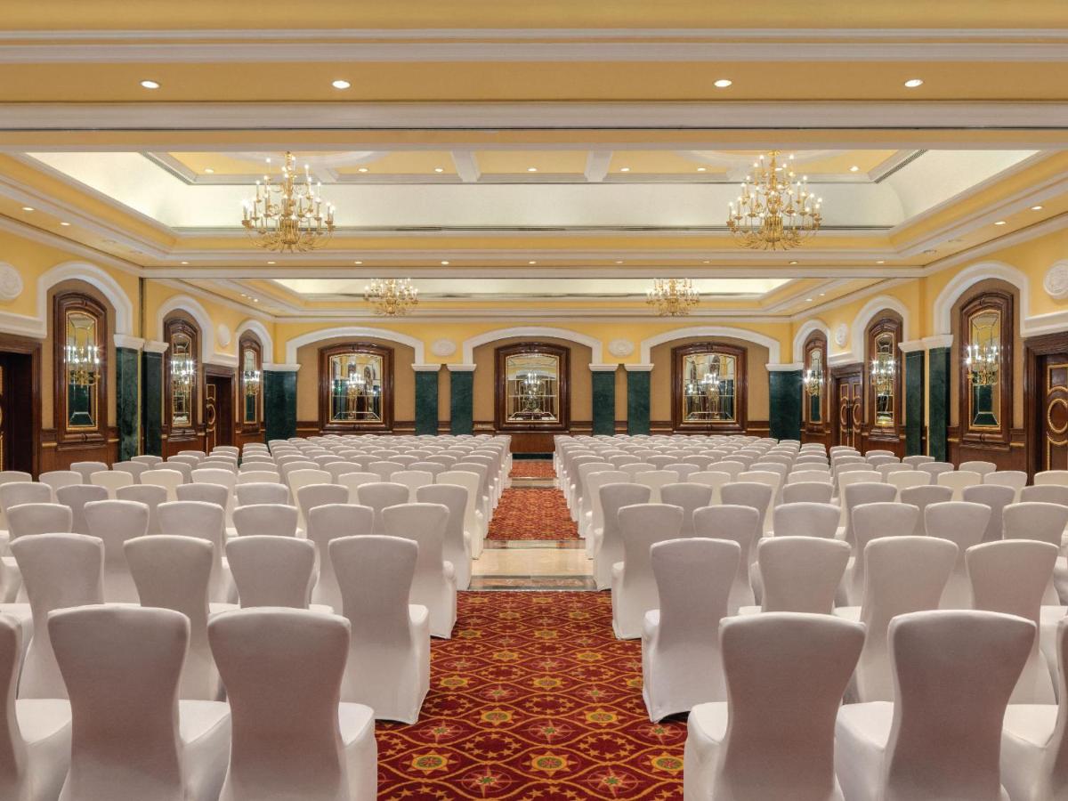 an empty banquet hall with white chairs and chandeliers at ITC Grand Central, a Luxury Collection Hotel, Mumbai in Mumbai