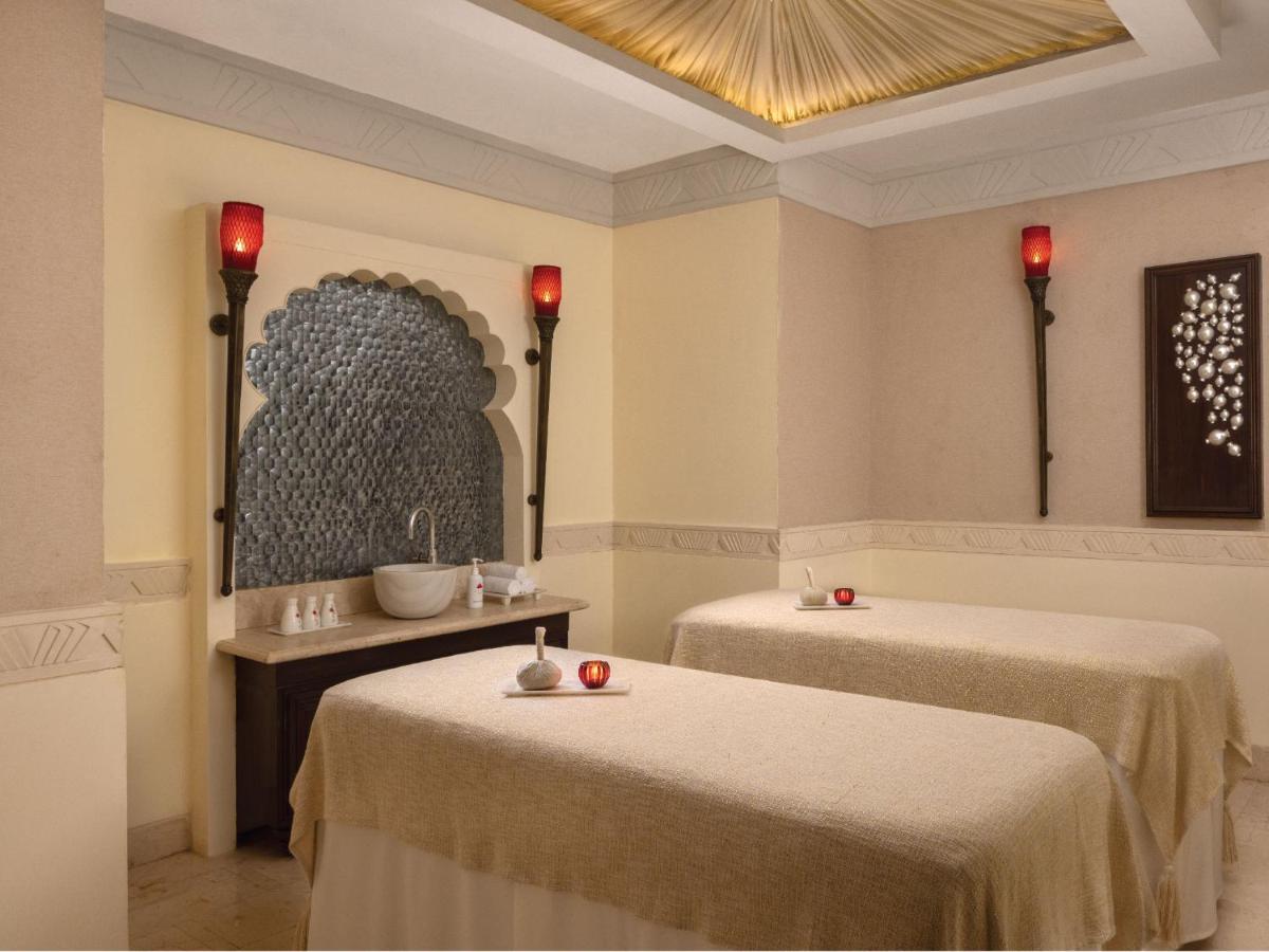a room with two beds and a chandelier at ITC Grand Central, a Luxury Collection Hotel, Mumbai in Mumbai