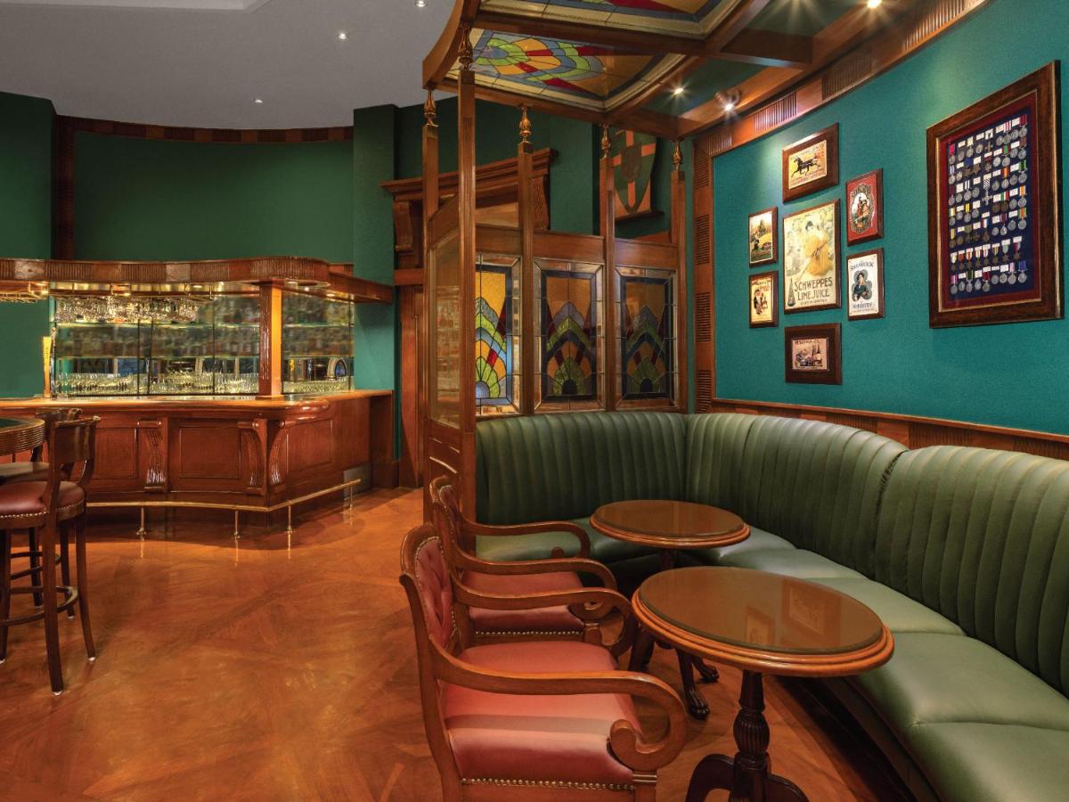 a bar with green walls and a green couch and tables at ITC Grand Central, a Luxury Collection Hotel, Mumbai in Mumbai