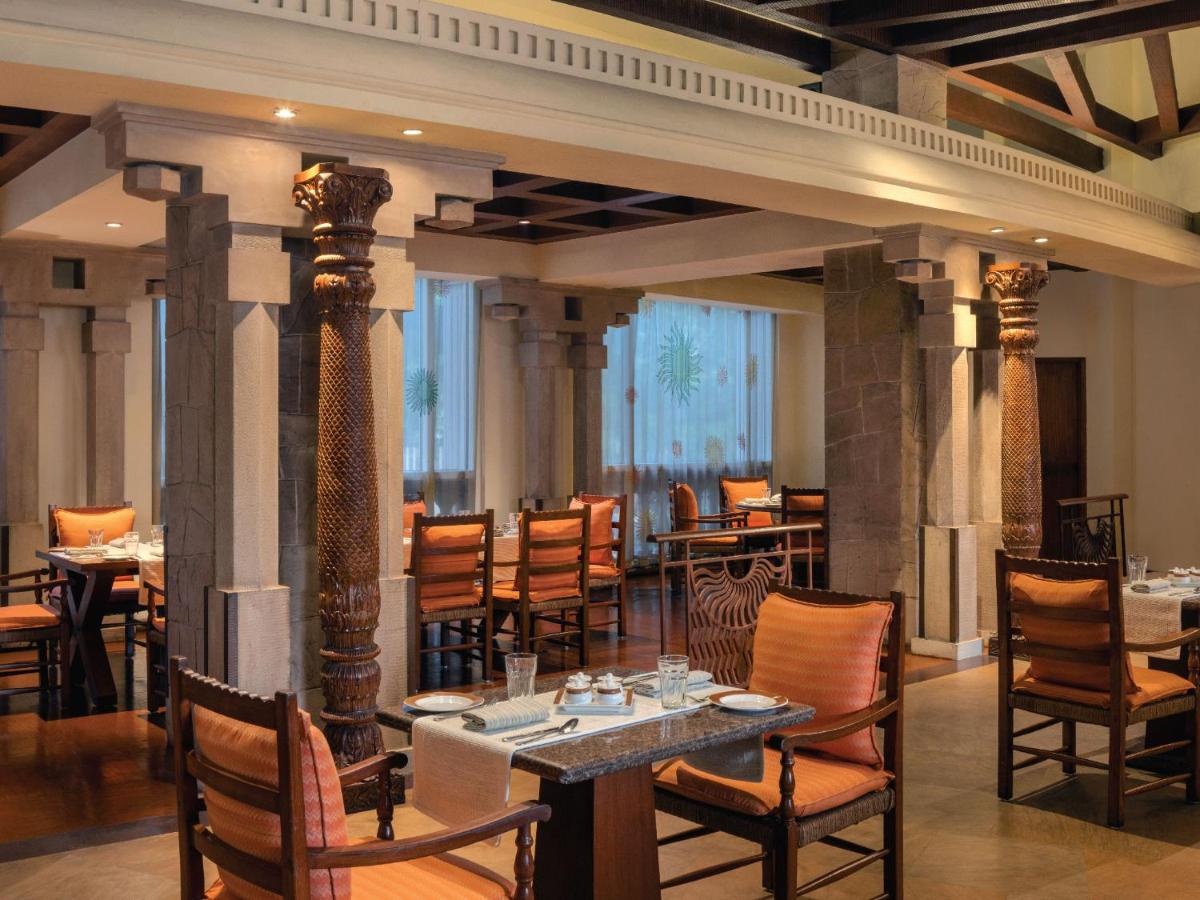 a restaurant with tables and chairs in a room at ITC Grand Central, a Luxury Collection Hotel, Mumbai in Mumbai
