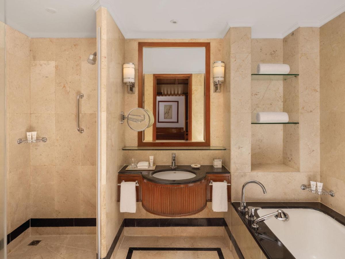 a bathroom with a tub and a sink and a mirror at ITC Grand Central, a Luxury Collection Hotel, Mumbai in Mumbai