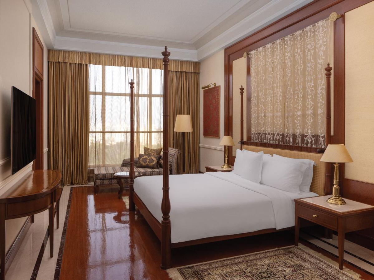 a hotel room with a bed and a desk and a desk at ITC Grand Central, a Luxury Collection Hotel, Mumbai in Mumbai