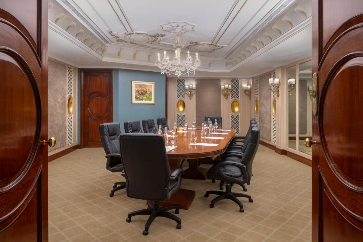 a conference room with a table and chairs at ITC Windsor, a Luxury Collection Hotel, Bengaluru in Bengaluru a conference room with a table and chairs at ITC Windsor, a Luxury Collection Hotel, Bengaluru in Bengaluru