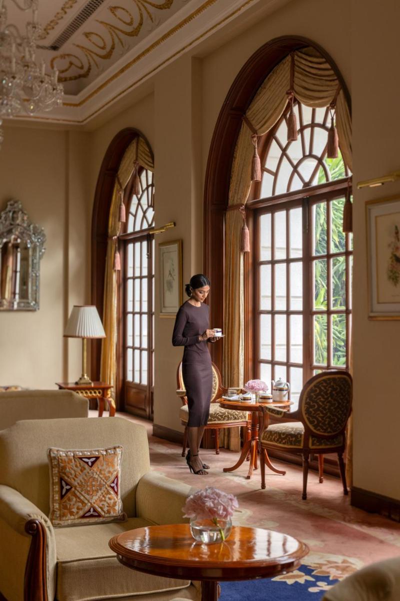 a pregnant woman standing in a room with windows at ITC Windsor, a Luxury Collection Hotel, Bengaluru in Bengaluru a pregnant woman standing in a room with windows at ITC Windsor, a Luxury Collection Hotel, Bengaluru in Bengaluru