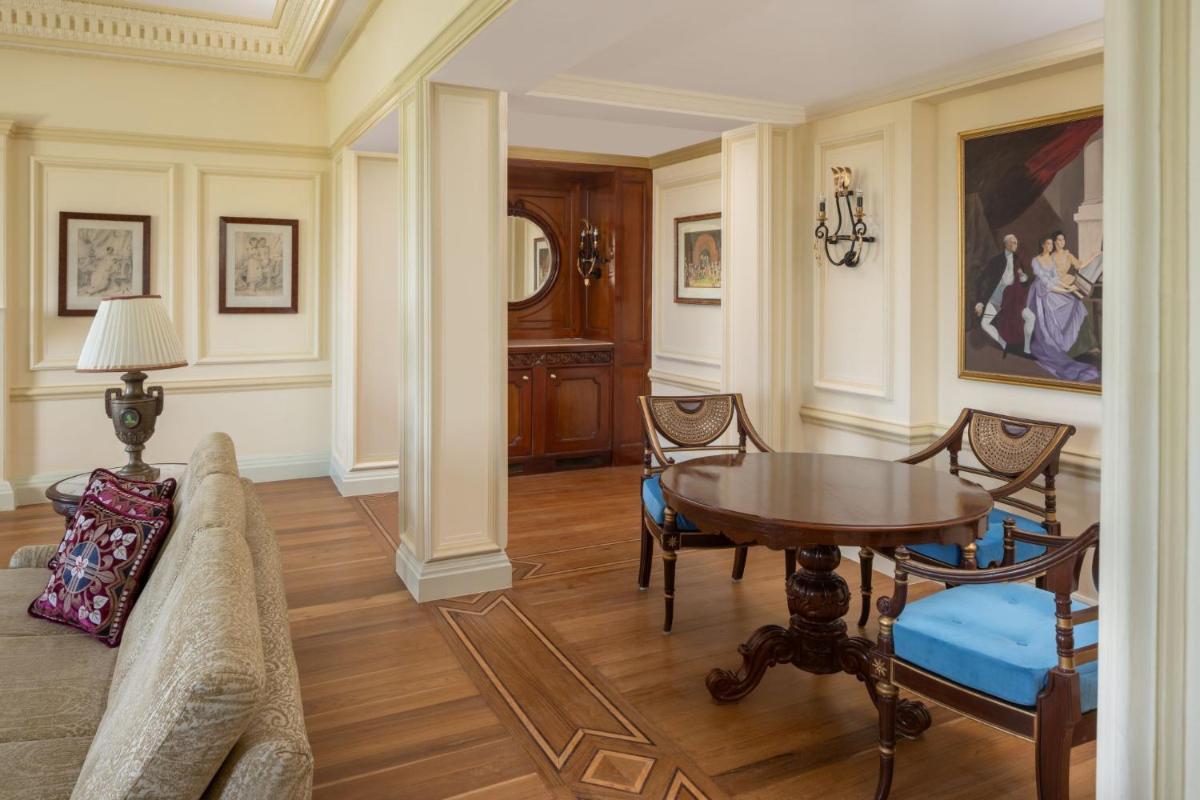 a living room with a table and a couch at ITC Windsor, a Luxury Collection Hotel, Bengaluru in Bengaluru a living room with a table and a couch at ITC Windsor, a Luxury Collection Hotel, Bengaluru in Bengaluru