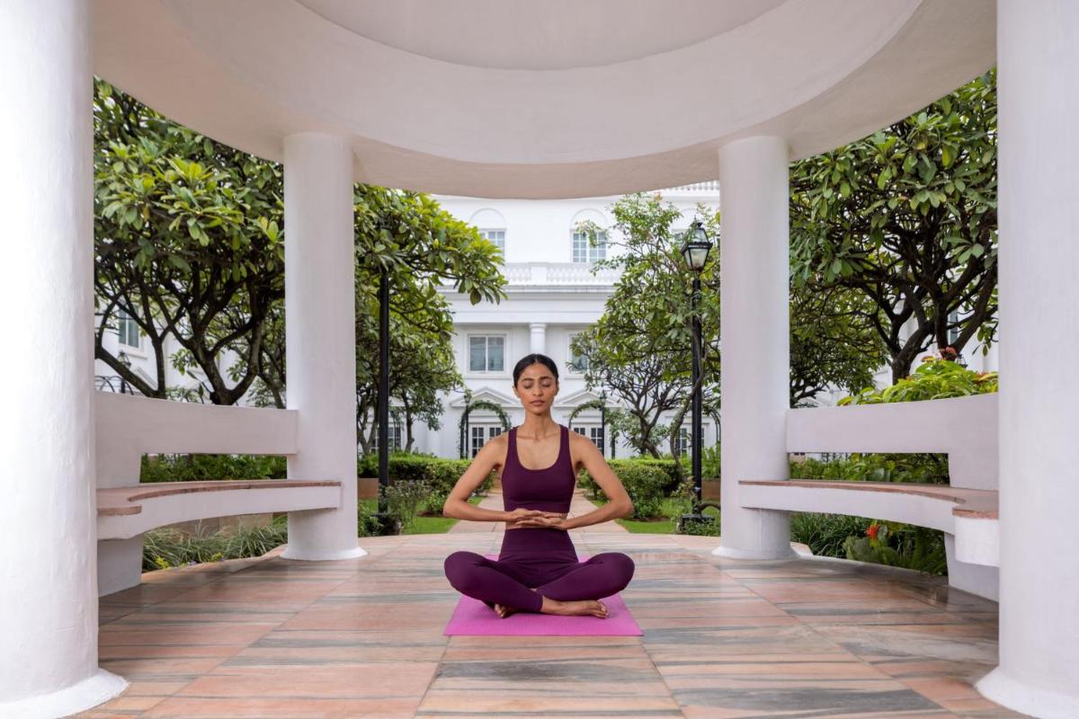 a woman in a yoga pose under a pavilion at ITC Windsor, a Luxury Collection Hotel, Bengaluru in Bengaluru a woman in a yoga pose under a pavilion at ITC Windsor, a Luxury Collection Hotel, Bengaluru in Bengaluru