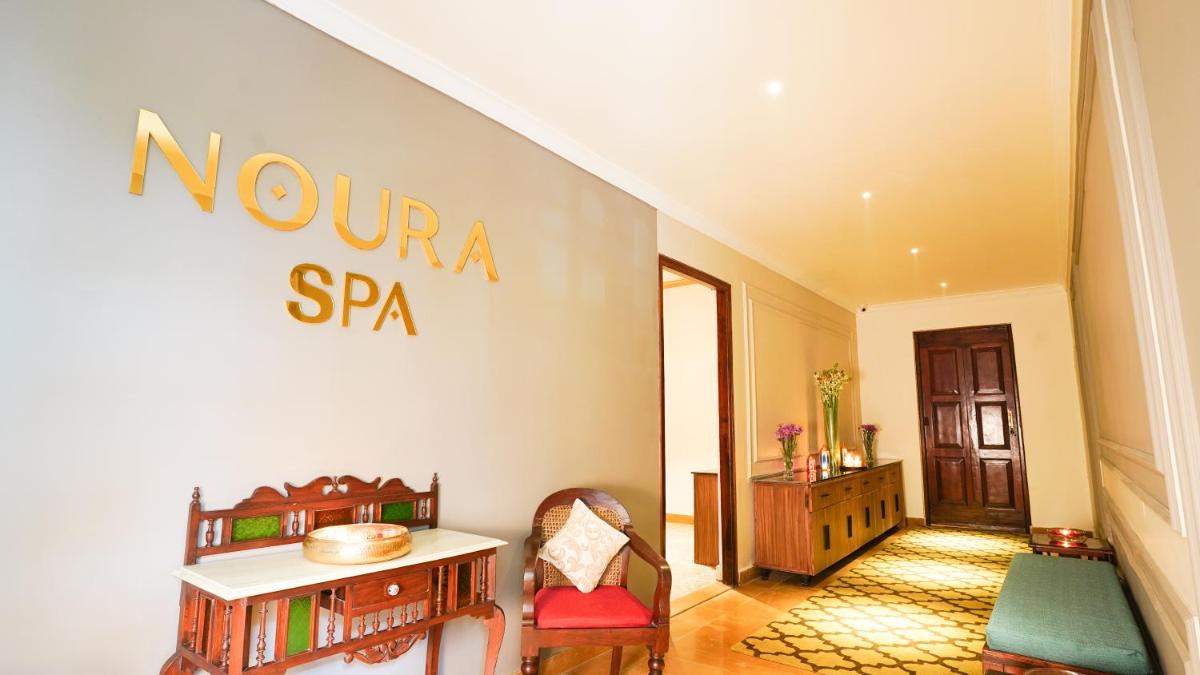 a room with a nordina sr sign on a wall at Saraca Hotel Lucknow in Lucknow