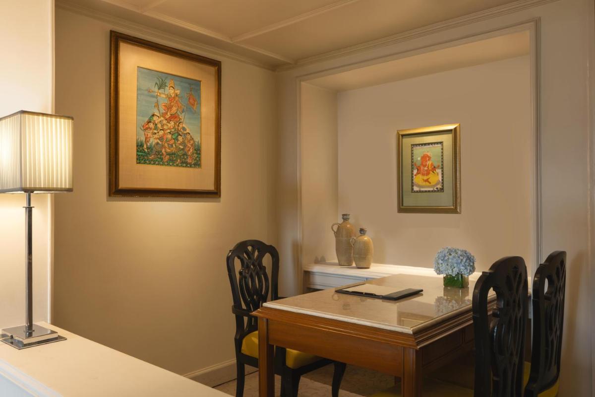 a dining room with a table and chairs at Taj Bengal in Kolkata