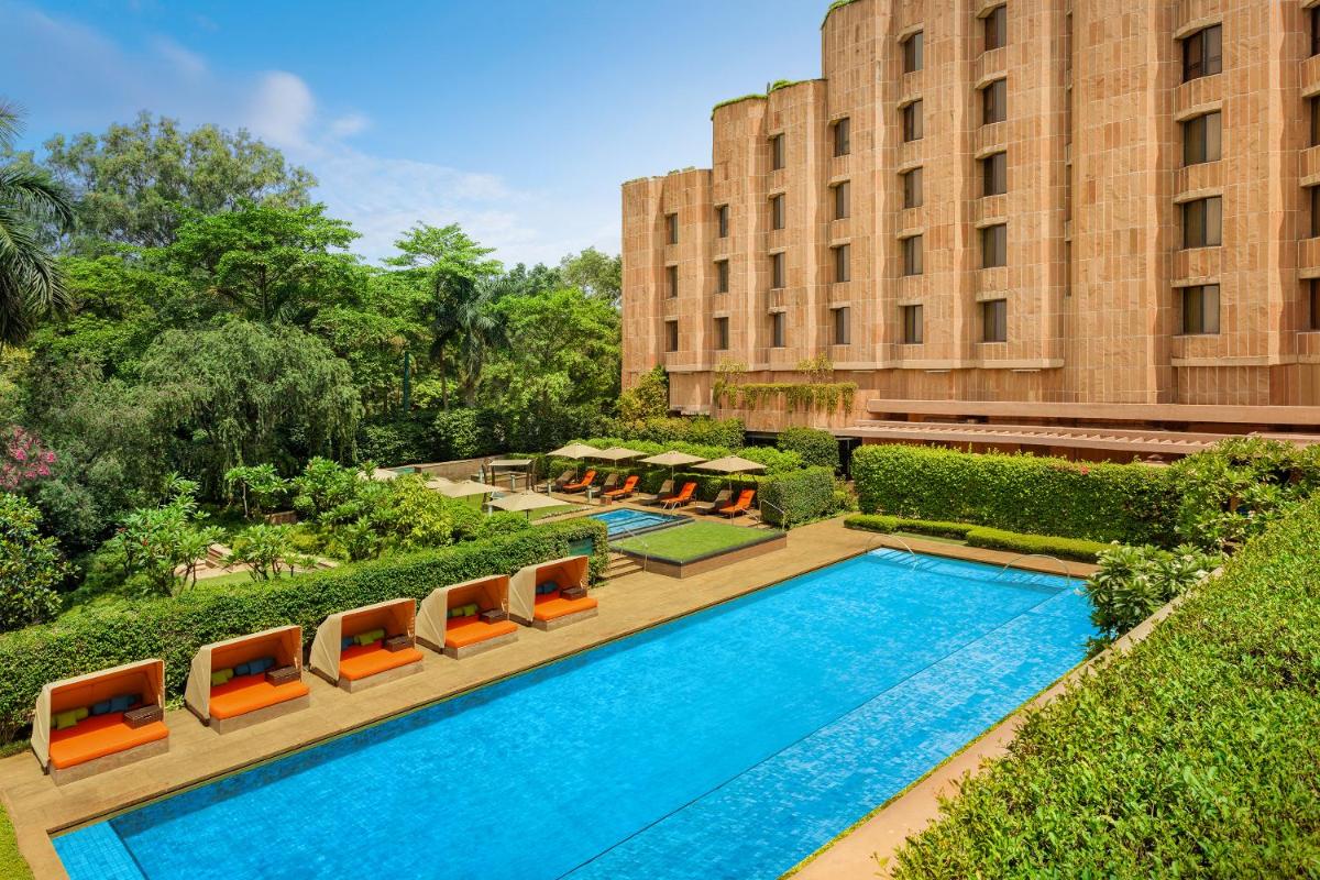 a swimming pool in front of a building at ITC Maurya, a Luxury Collection Hotel, New Delhi in New Delhi a swimming pool in front of a building at ITC Maurya, a Luxury Collection Hotel, New Delhi in New Delhi