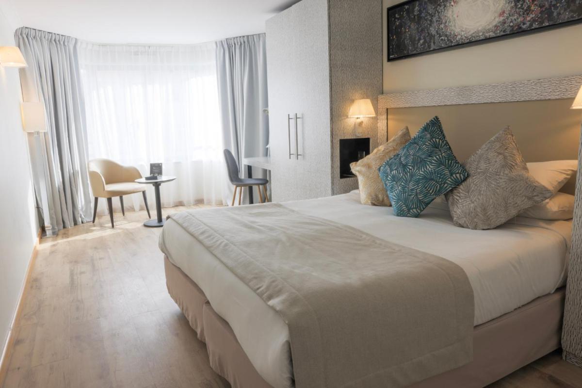Un ou plusieurs lits dans un hébergement de l'établissement Eden Hotel & Spa