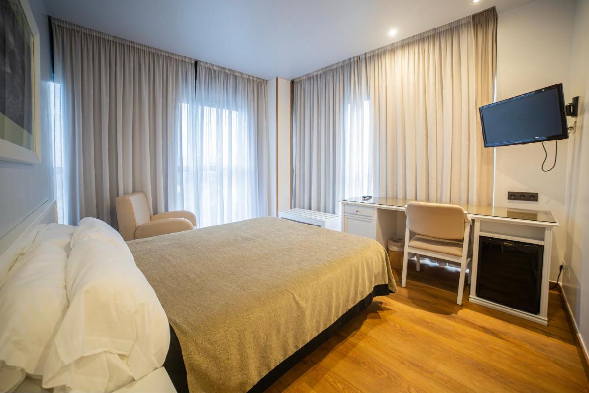 Cama o camas de una habitación en Hotel Auditorio Santiago & Spa
