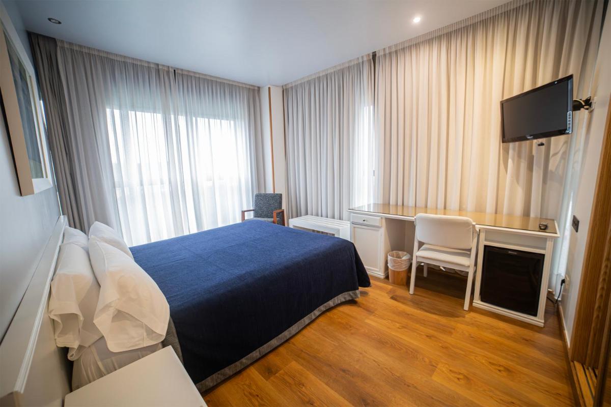 Cama o camas de una habitación en Hotel Auditorio Santiago & Spa