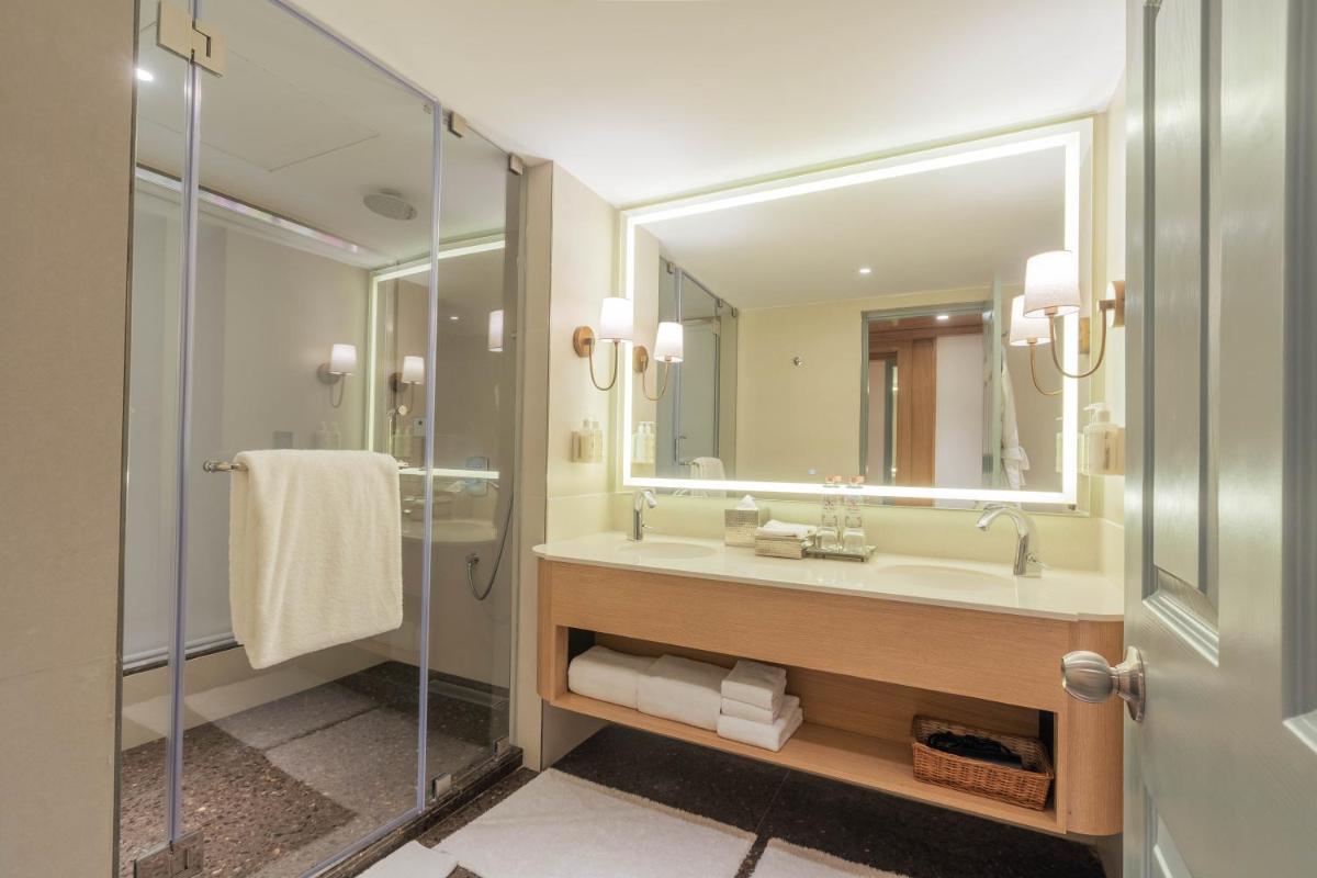 a bathroom with a sink and a mirror at Hotel Royal Orchid Bangalore in Bengaluru