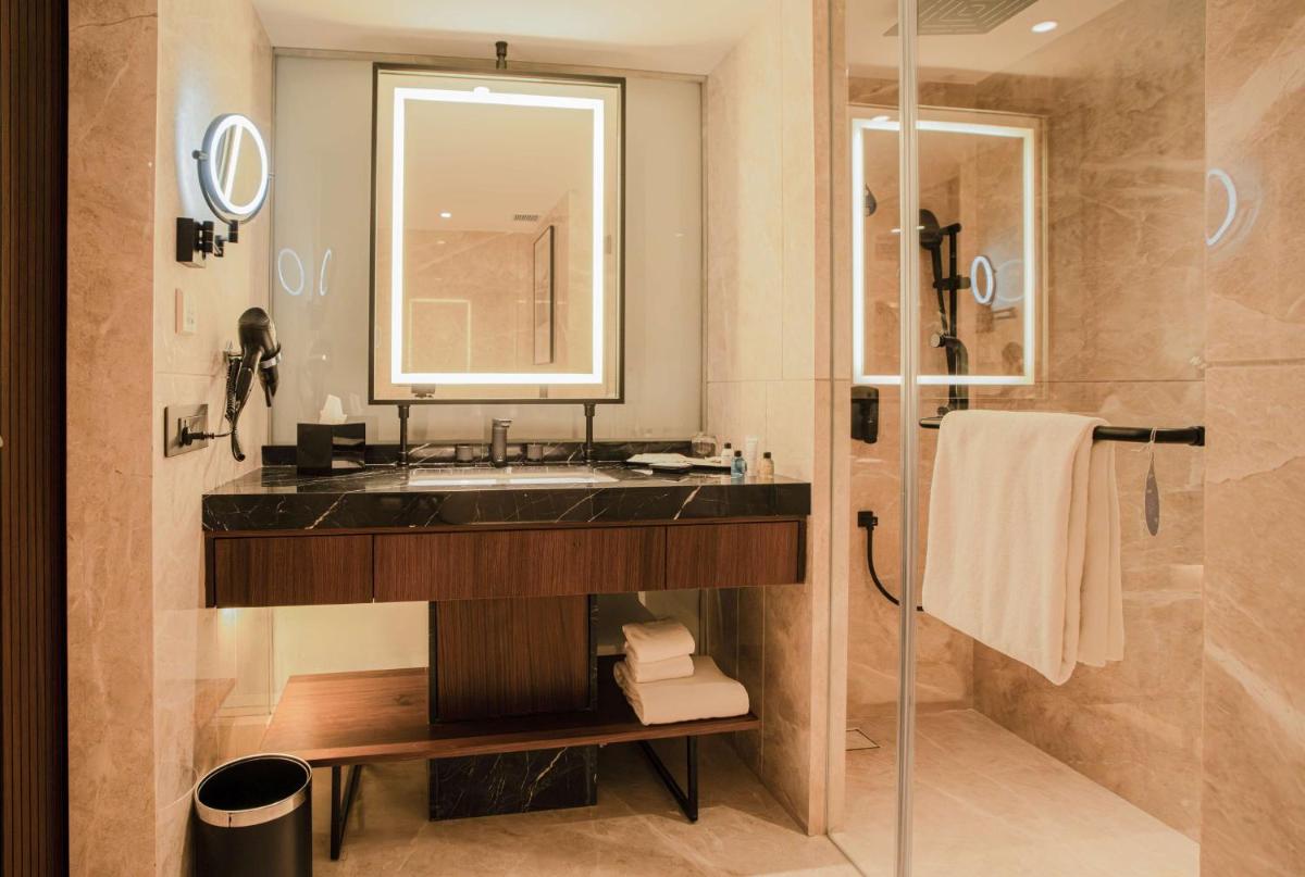 a bathroom with a sink and a shower at Radisson Blu Hotel Ahmedabad in Ahmedabad