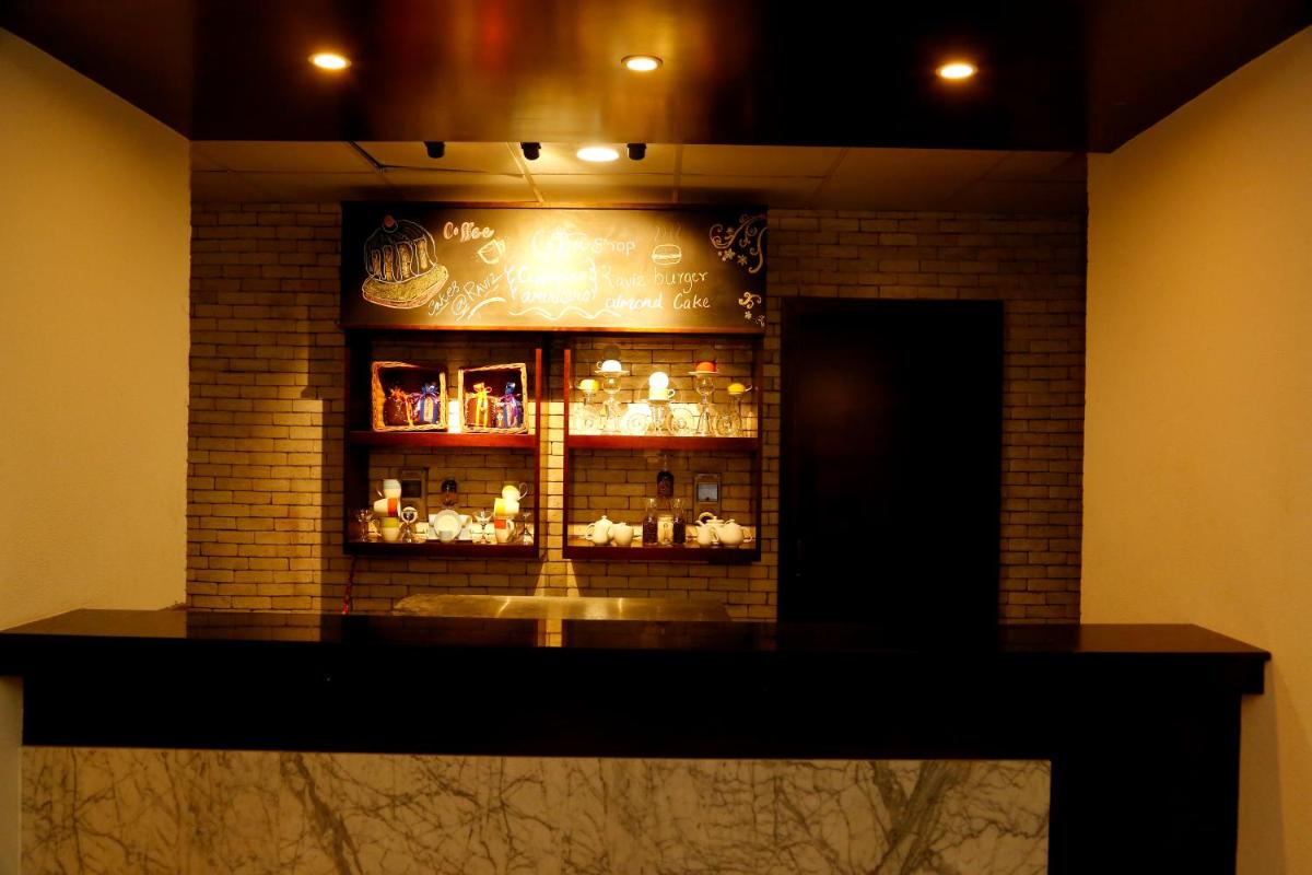 a display case in a room with a brick wall at The Raviz Calicut in Kozhikode
