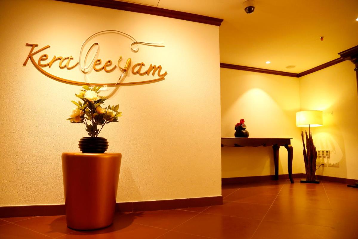 a store with a sign on the wall with flowers in a vase at The Raviz Calicut in Kozhikode
