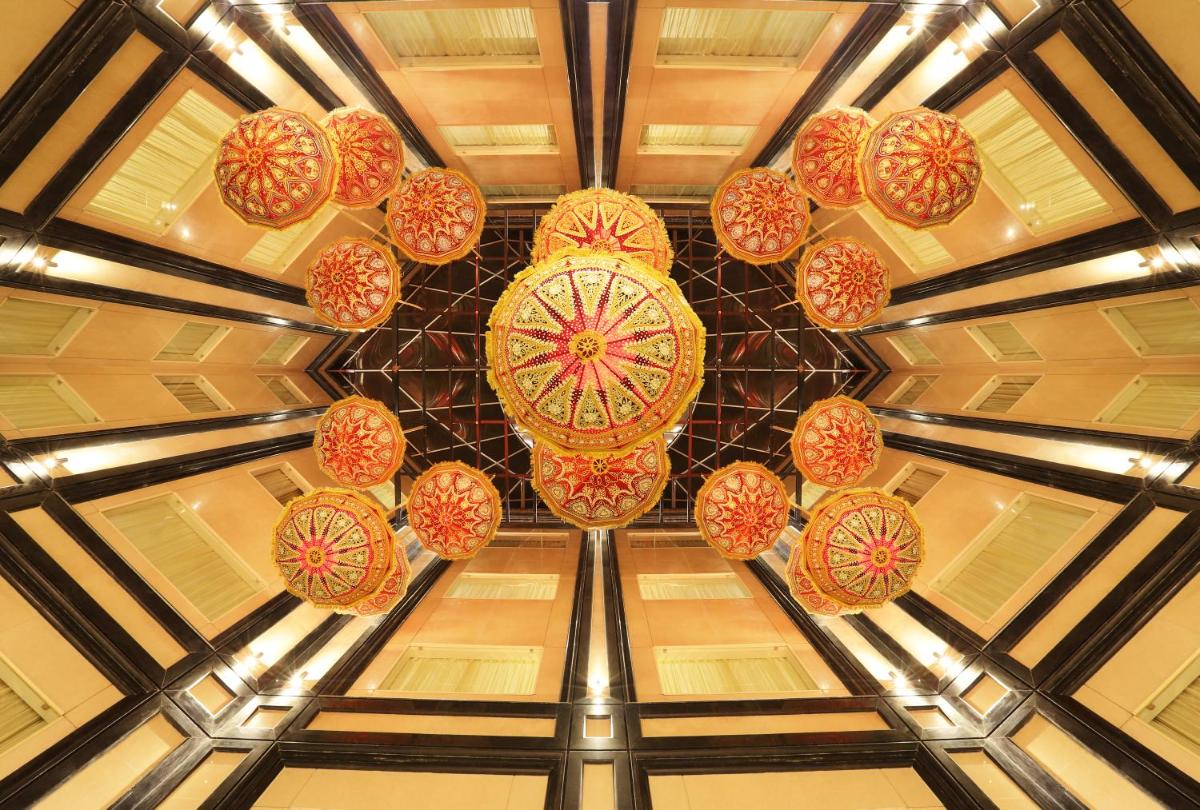 a bunch of colorful lights hanging from a ceiling at Golden Tulip Jaipur in Jaipur