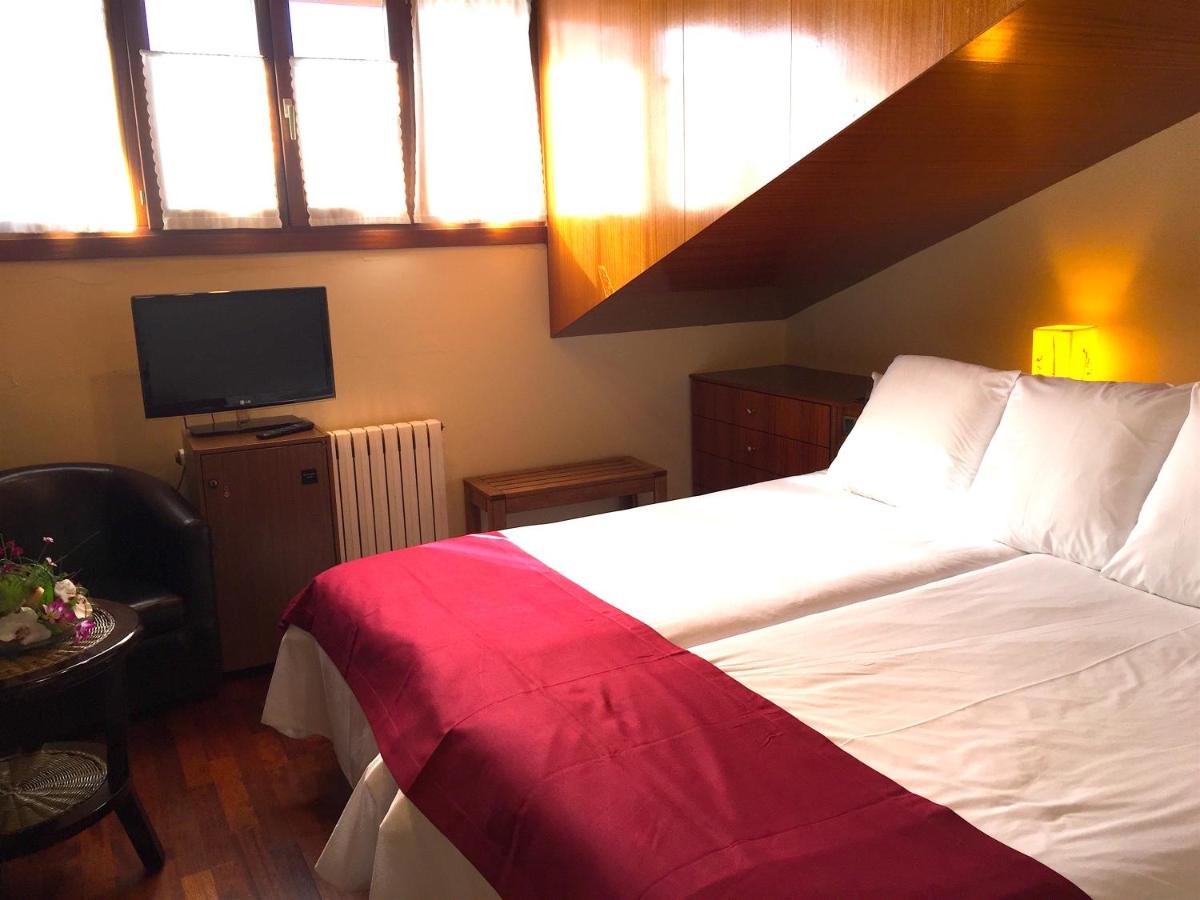 Cama o camas de una habitación en Hotel Del Lago