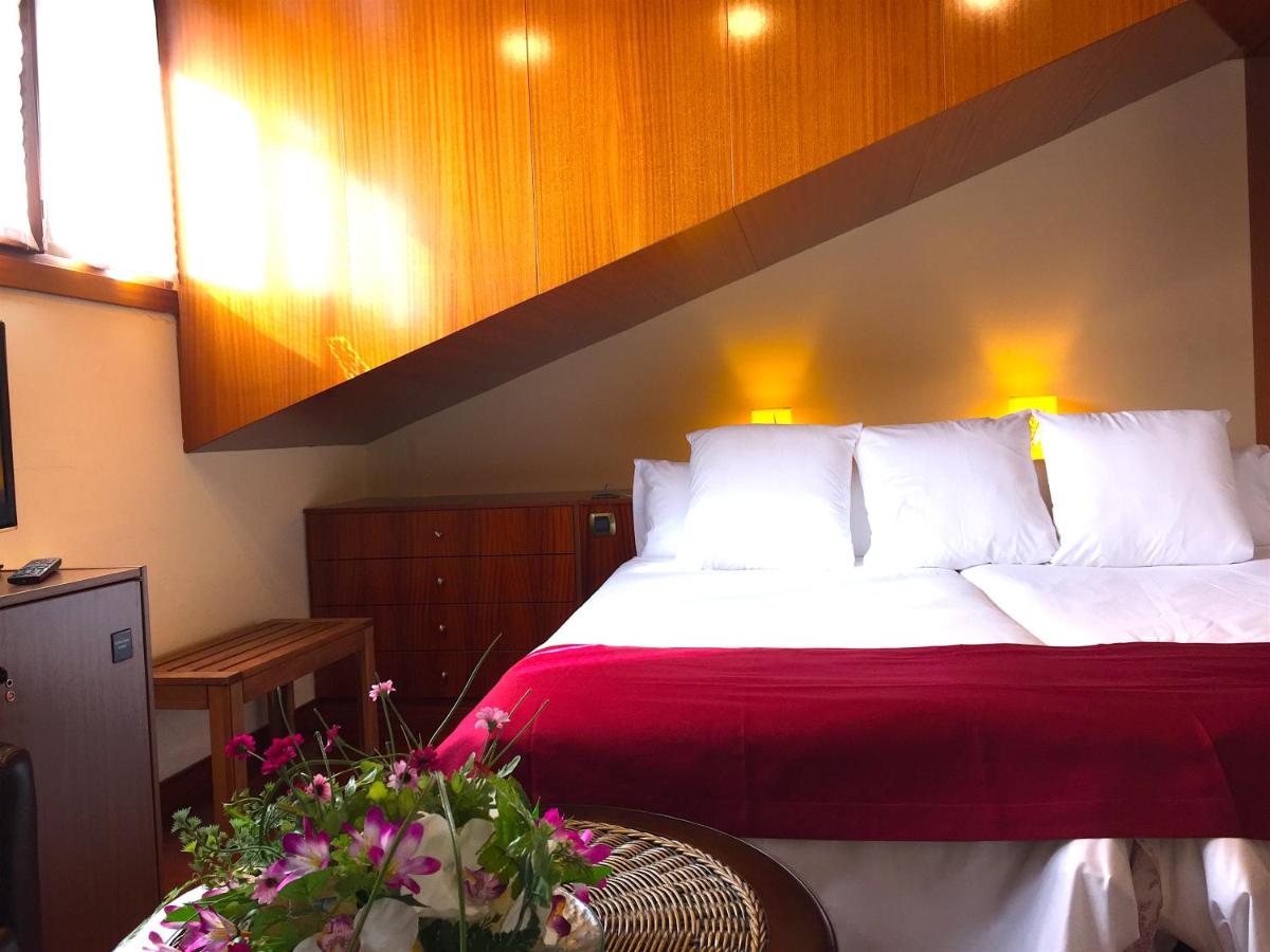 Cama o camas de una habitación en Hotel Del Lago