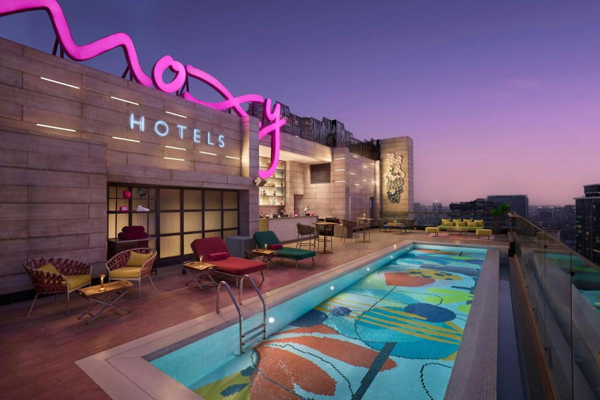 a hotel pool on the rooftop of a building at Moxy Mumbai Andheri West in Mumbai a hotel pool on the rooftop of a building at Moxy Mumbai Andheri West in Mumbai