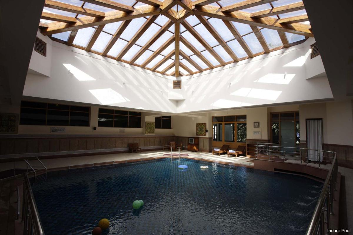 a large swimming pool with a large ceiling at Jaypee Residency Manor in Mussoorie a large swimming pool with a large ceiling at Jaypee Residency Manor in Mussoorie